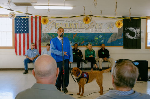 cmc dog handlers presenting with their service dogs in training