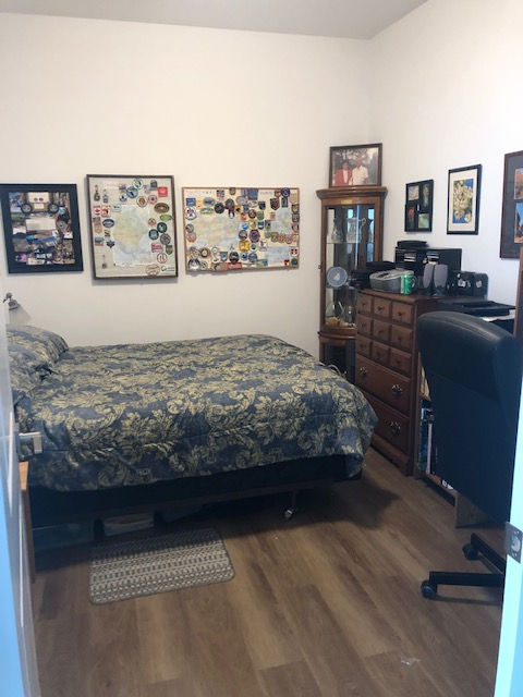 All of the furniture is put away in correct spots, boxes have been emptied and are gone, art is on the wall and it looks inviting for work or a nap as the multipurpose room should.