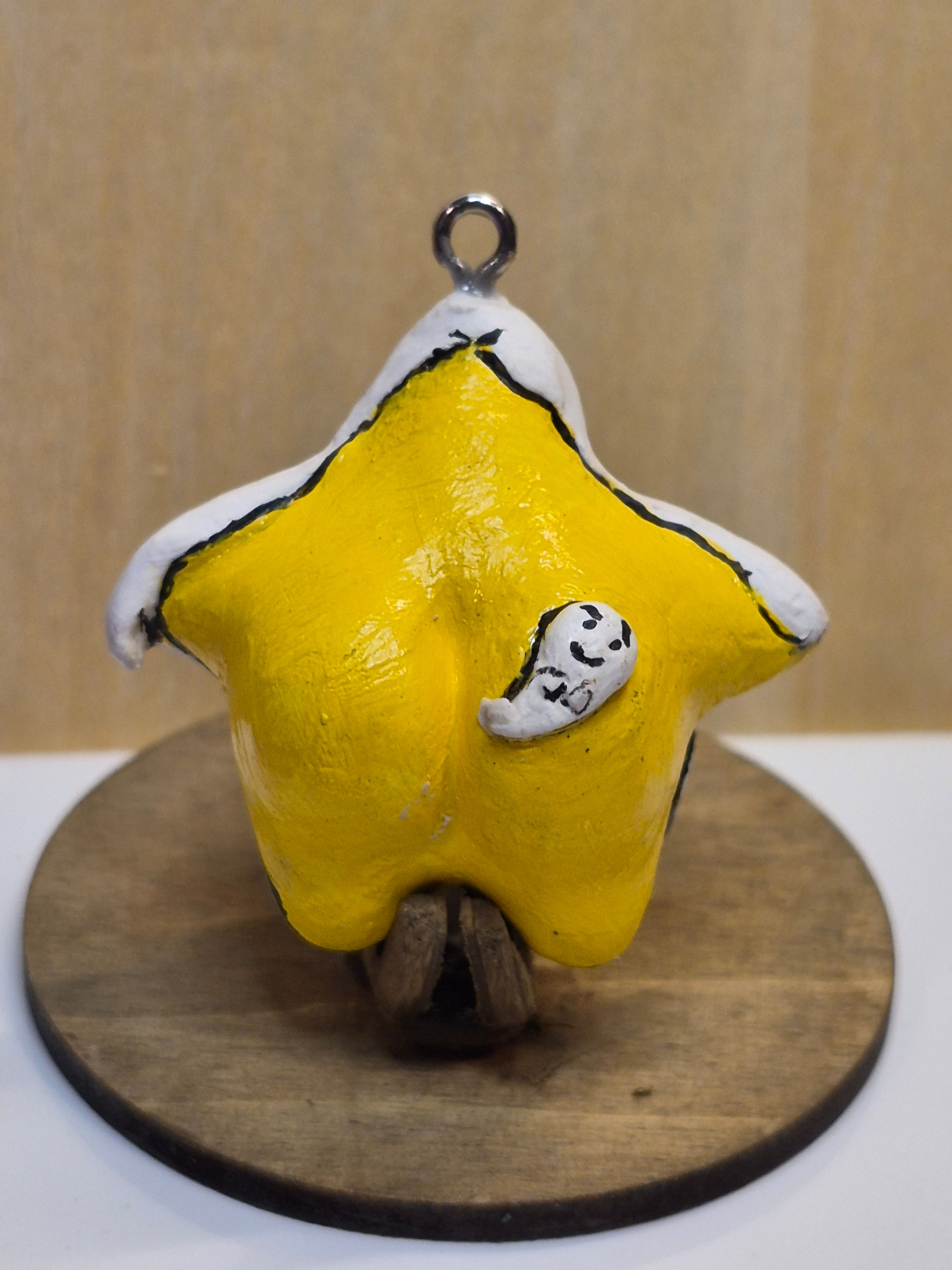 Back view of handmade ceramic Ghost Star showing bright yellow star and white ghost