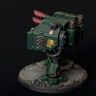 Left view of Dark Angels Dreadnought with laser cannon and missiles launcher. Painted in green with native americans freehand paintings. Plastic, painted warhammer 40k miniature vehicle by the artist Hawk Talon.