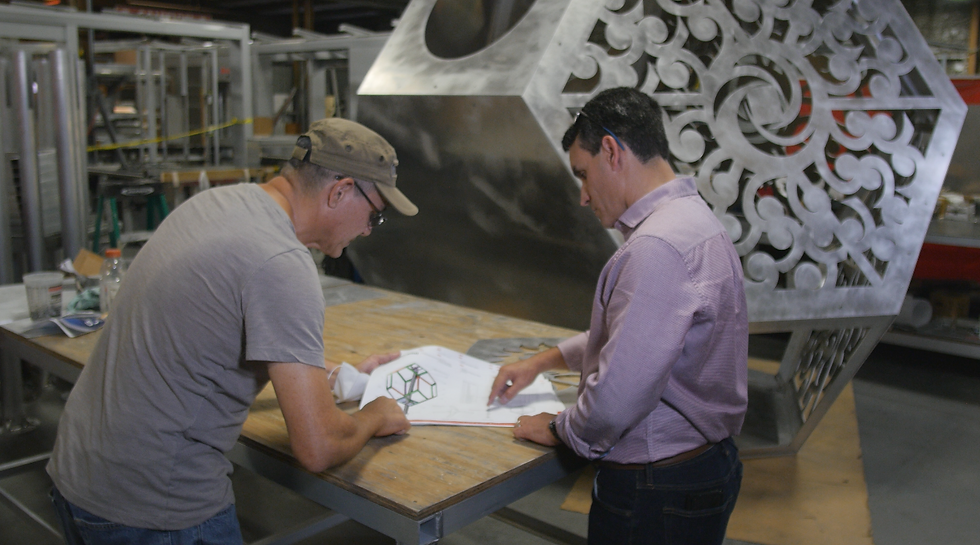 Jose Costa reviewing plans with a specialty fabricator