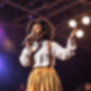Black female high school student singing on stage.jpg