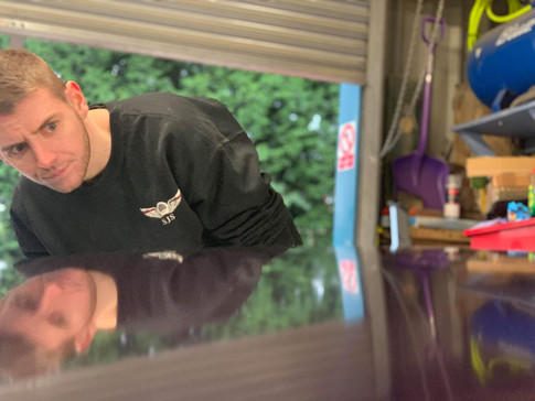 Steve Swann carrying out flattening to an MGB bonet ready for polishing.