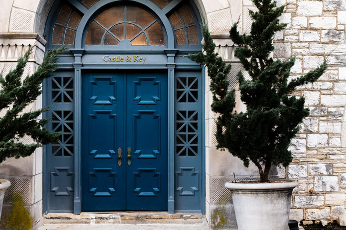 Blue door with the text "Charlie & Ray" and stone background.