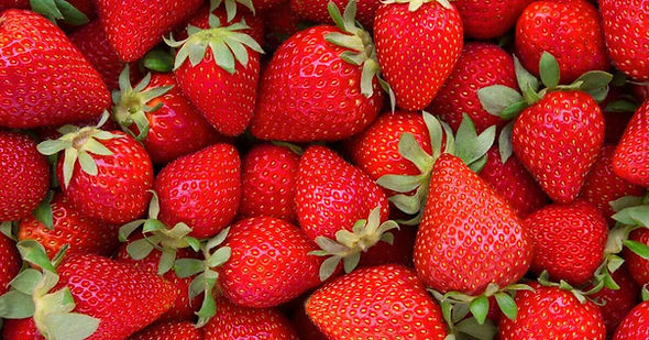 Pile of fresh red strawberries, a delicious and juicy fruit.