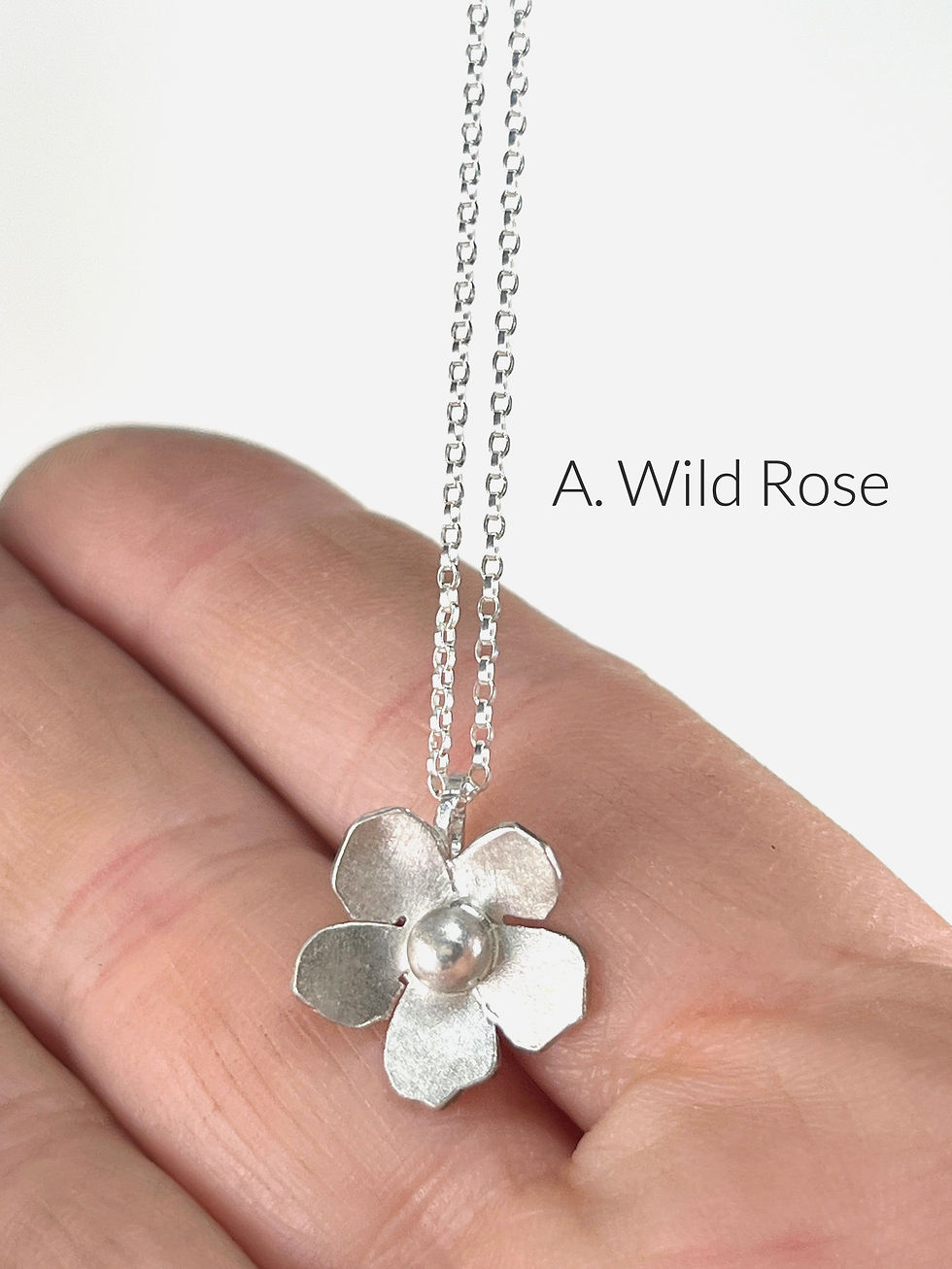wild rose sterling silver  flower blossom necklace close up in hand