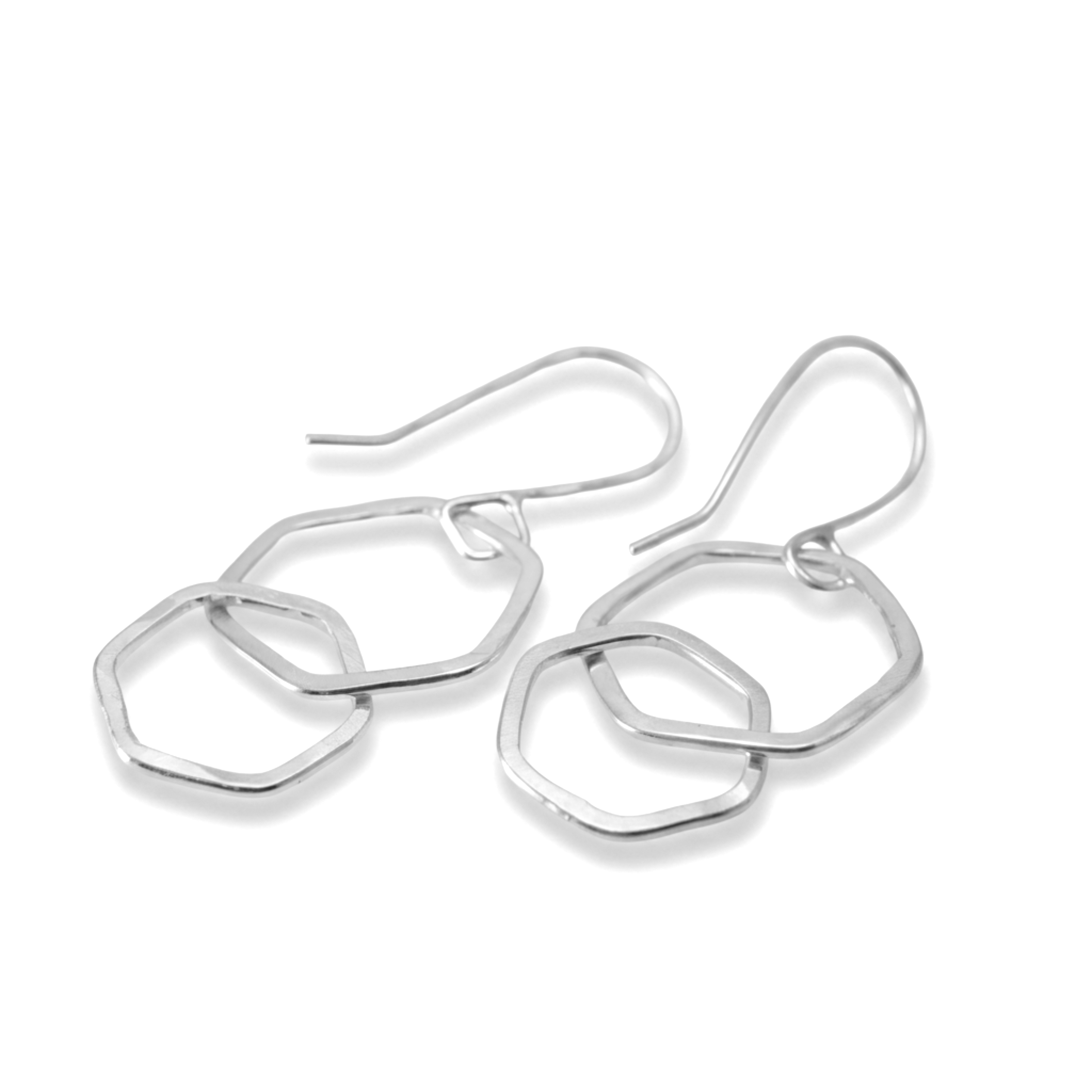 sterling silver hexagon earrings with two interlinked dangle shapes on white background