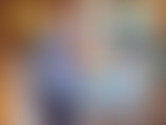 An RHPL Lobby stop patron stands in front of carts of books, holding a small dog.