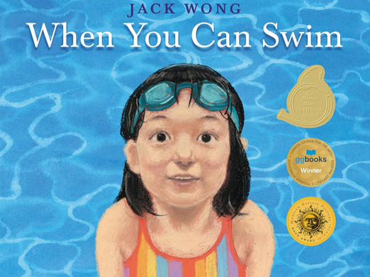 Cover of the book: When You Can Swim. A girl with googles on her forehead looks out at the reader with a wide-eyed, contented look. Three gold seals adorn the cover, denoting the book's awards: the Horn Book Fanfare Best Book, the Governor General's Literary Award, and the Marilyn Baillie Picture Book Award.