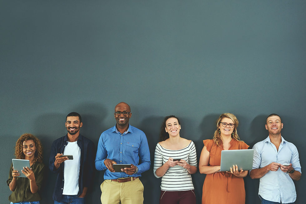 A group of smiling people holding different devices