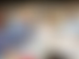 A group of adults with open books, smiling and talking with each other.