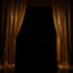 Stage dark background framed on each side by gold curtain_.jpg
