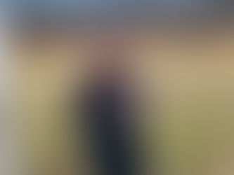 Author K. Cardella in a backyard holding her book, "The Black Lotus."