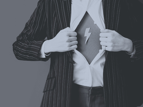 Button up shirt being opened to reveal a superhero style logo