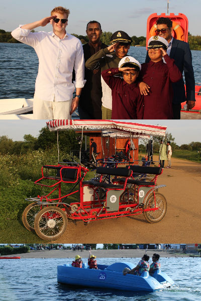A group riding a four-wheeled Chuckle Bike on the path by the lake at Fairlop Waters