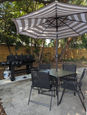 Outdoor dual BBQ Grill and outdoor dinning table with umbrella.