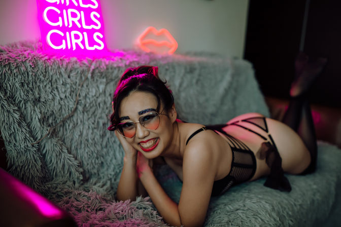 classic boudoir pose with neon lights