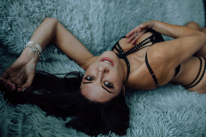 lying on green carpet boudoir photography