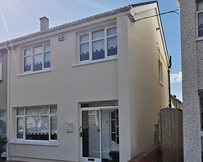 Semi-detached house with light cream acrylic render finish