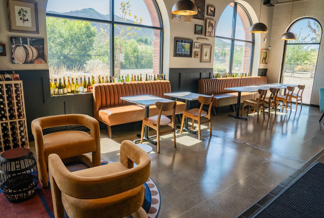 Modern wine bar interior at The Humble Somm in Temecula featuring warm lighting, wood accents, and an inviting lounge atmosphere.