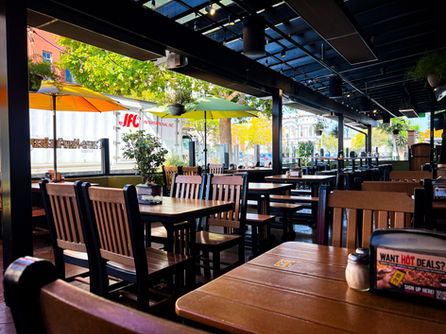 Interior design of Woodstock’s Pizza Santa Cruz — a surf-and-skate-inspired pizzeria blending California coastal energy with rustic wood textures, neon signage, and playful vintage accents by Crave Design Co