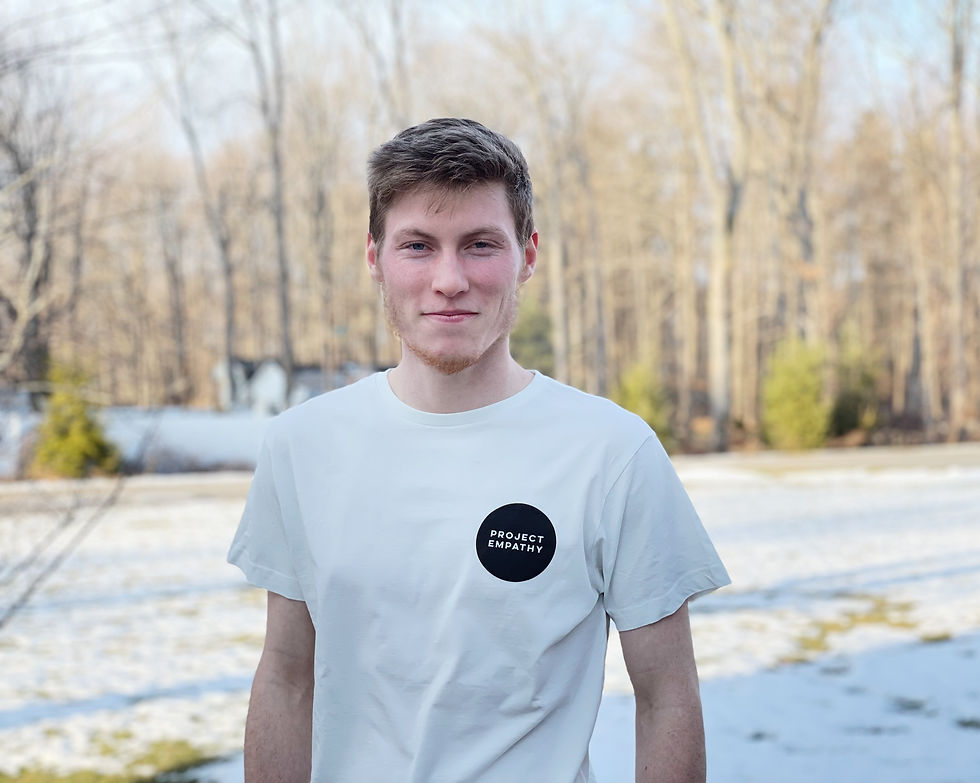 Thumbnail: Man wearing white Project Empathy t-shirt