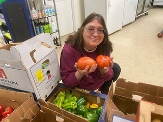Peggy shows off tomatoes.