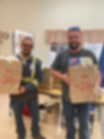 Staff from TCI of NY drop off food donations.