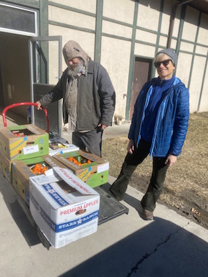 Volunteers help with produce.