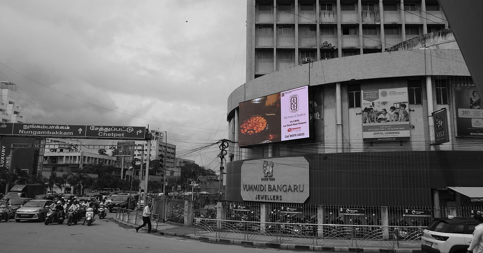 Colorful digital billboard on a building in a monochrome city
