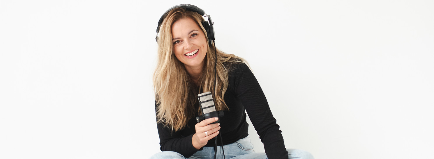 Host of her theology with earphones on and microphone ready to record another episode of the christian womens podcast her theology