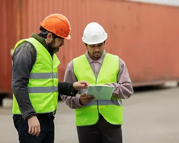 2 men working at ship management company