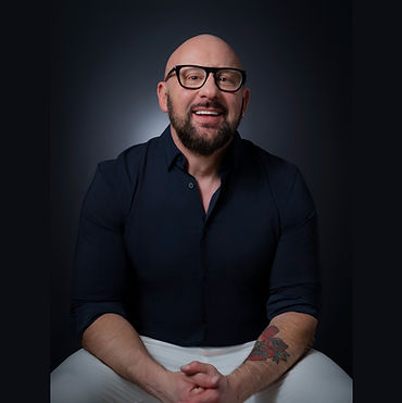 GreggSeatedFrontalSmilingGlasses_V1.jpg