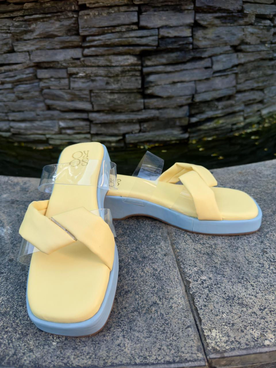 Thumbnail: Pair of yellow sandals with TWO TONE PLATFORM - Yellow, resting on stone wall.