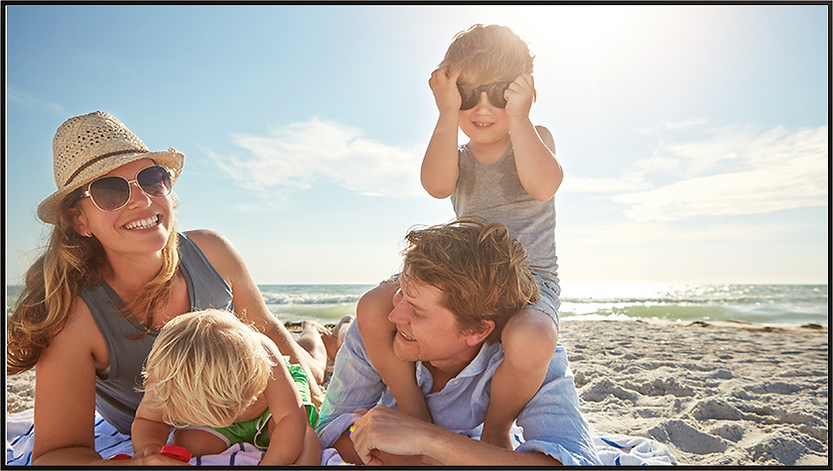 Family enjoying time together on a sunny beach.