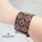 A woman's wrist with a beaded bracelet.