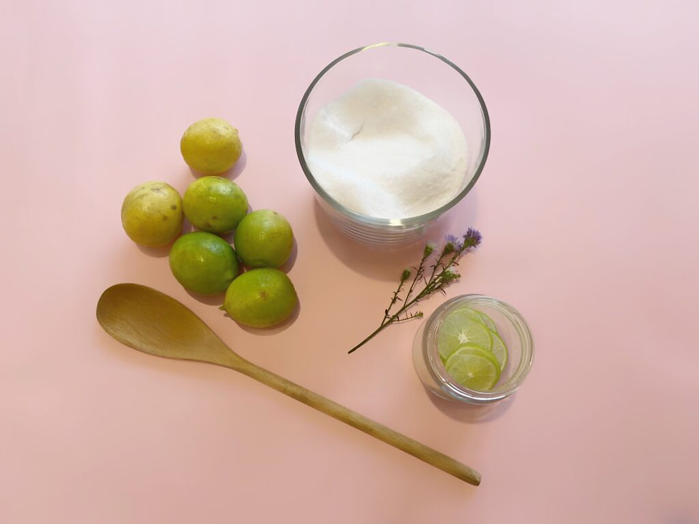 ingredients for lime ade, sugar and sliced limes