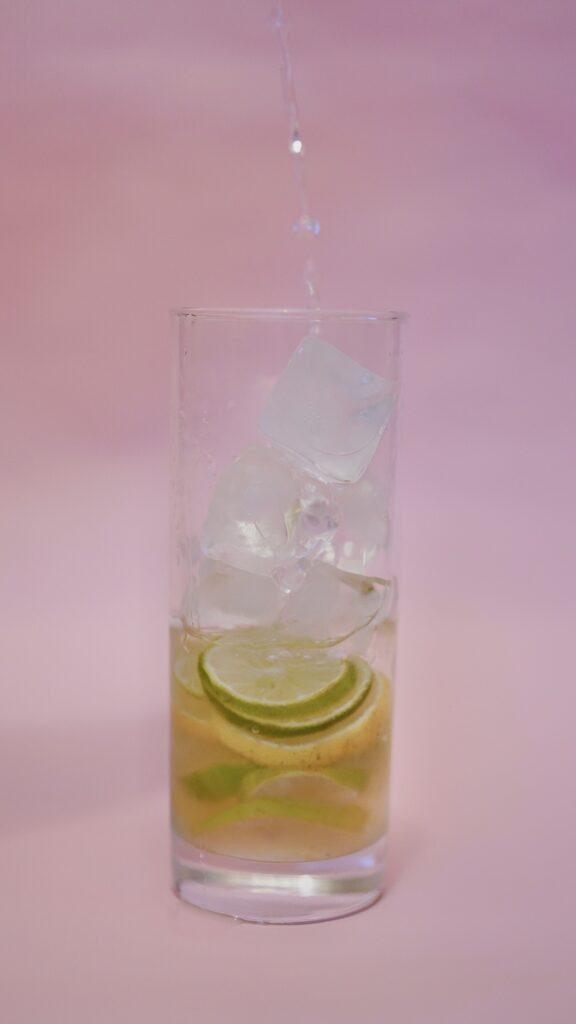 lime ade mix with ice and water in a glass