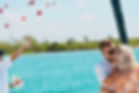 Couple kissing on luxury yacht during wedding celebration at sea in Riviera Maya