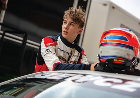 Jack Szewczuk beside his race car at Sydney Motorsport Park