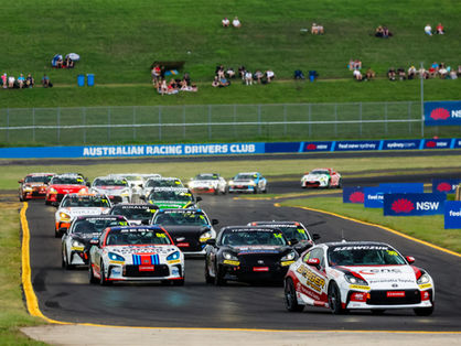 GR Cup field racing past the grandstand
