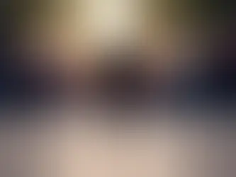 Soft focus crowd at dusk with a solitary backlit silhouette in the foreground.