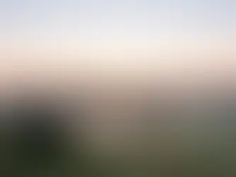 Fog lifting over a valley at sunrise with open sky space, setting a calm hero banner about getting legal help.
