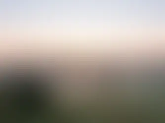 Fog lifting over a valley at sunrise with open sky space, setting a calm hero banner about getting legal help.