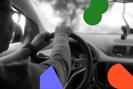 black and white photo of driver driving a car, with branded coloured icon overlay
