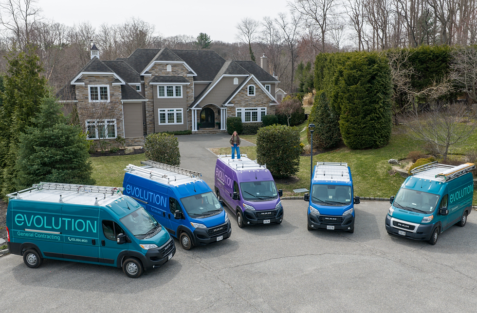 An image of Jennifer DeVito, the owner of Evolution General Contracting and her trucks.