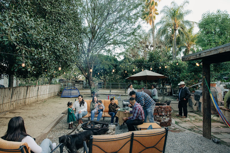A family sitting on their patio furniture in their backyard