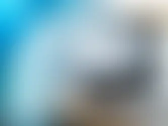 Laptop screen displaying analytics data with a blurred blue background, representing keyword research and SEO metrics.