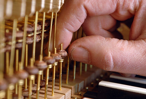 Hand tuning a pipe organ close up.jpg