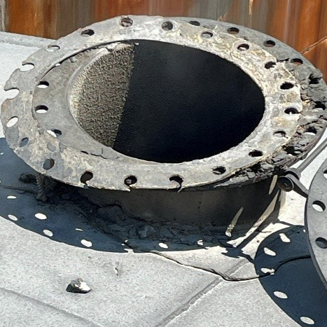 Damaged nozzle on the outside of a tank